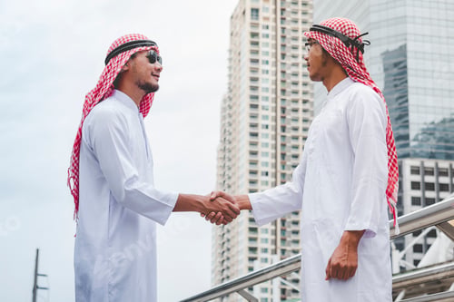 Preview: Arab Businessman shaking hands together. Teamwork business partner wear Muslim dress Shake Hands