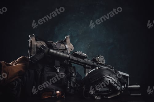 Preview: Militray equipment and weapons on a table in dark background