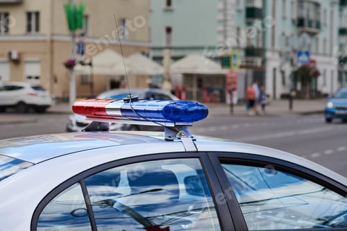 Preview: Police car lightbar closeup against city street