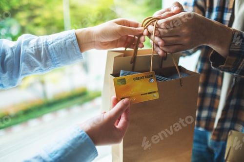 Preview: A woman receive shopping bags form delivery man and using a credit card for payment
