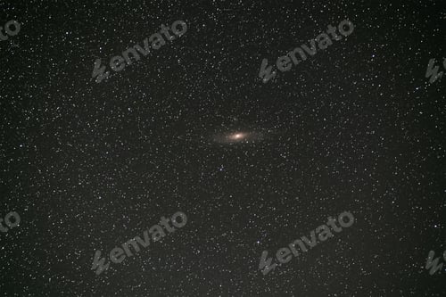 Preview: Black night stars covered sky with bright Andromeda galaxy in the middle