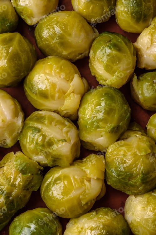 Preview: Delicious boiled Brussels sprouts on a ceramic plate on a dark concrete background