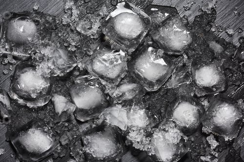 Preview: Heap of crushed melting ice cubes on the black background