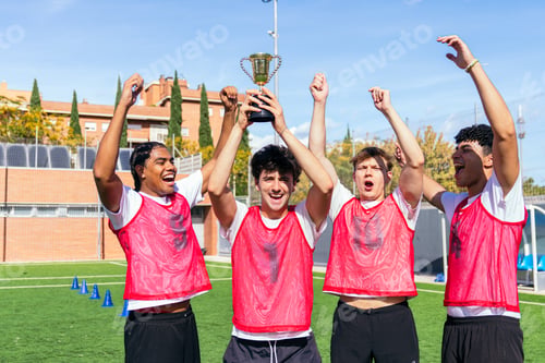 Preview: Young soccer players celebrating trophy victory on field
