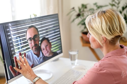 Preview: Young woman having video call with husband and son, social distancing concept