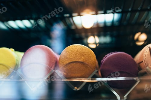 Preview: Multicolored macarons on a showcase in a cafe