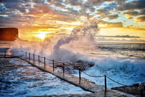 Preview: Early morning waves breaking over the local ocean pool