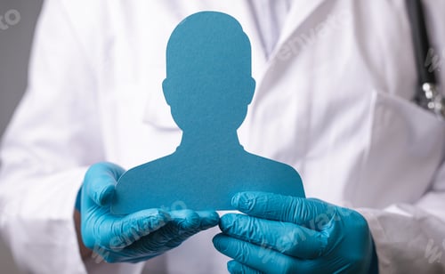 Preview: Papercut of a male figure in the hands of a doctor with medical gloves