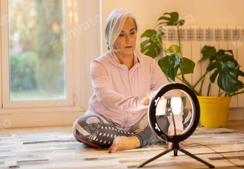 Preview: Senior Woman Setting Up Ring Light for Online Workout