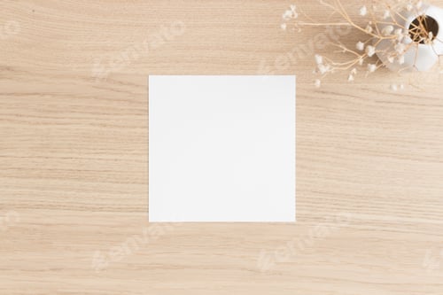 Preview: Square invitation card mockup with a gypsophila on the wooden table.
