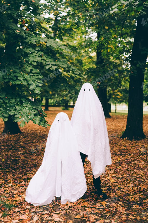 Preview: Two playful ghost costumes in an autumn park