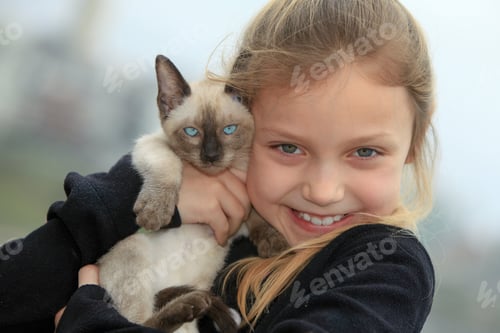 Preview: Young Girl Holding Kitten Outdoors
