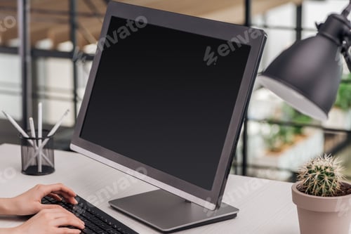 Preview: cropped view of woman typing on computer keyboard at workplace