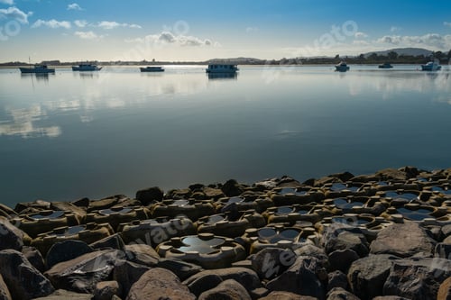 Preview: Tranquil seascape with boats on calm water under a blue sky