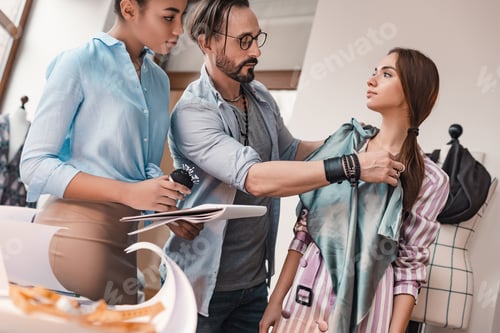 Preview: Taking measures and chooseing material. Group of three people at design studio