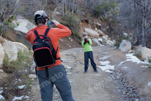 Preview: Man photographing son holding snowball in Andes, Valparaiso, Chile