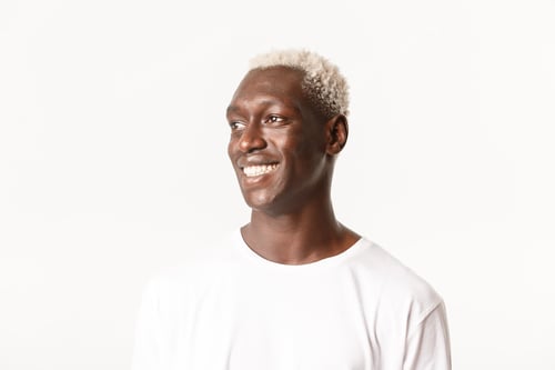 Preview: Close-up of hopeful and happy handsome african-american young man looking away with pleased smile