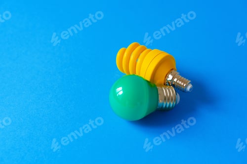 Preview: Light bulbs on blue paper background close up