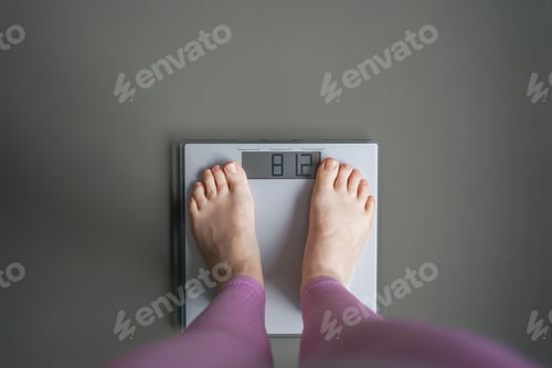 Preview: Woman watching her weight . Weight loss. Healthy weight.