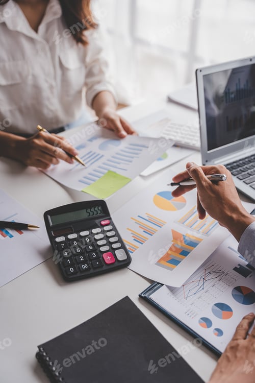 Preview: Business Professionals Reviewing Financial Charts in the Office