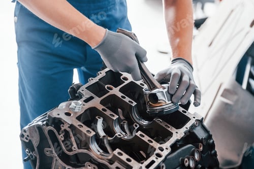 Preview: Professional repairman works with broken automobile engine