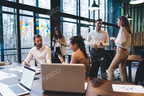 Preview: Coworkers working and communicating in office