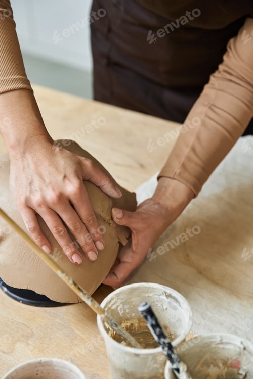 Preview: A couple sharing creative moments while crafting pottery in a modern studio