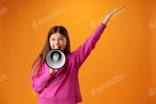 Preview: Teen girl making announcement with megaphone on yellow background