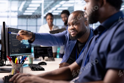 Preview: IT expert showing intern how to ensure data center equipment operates efficiently