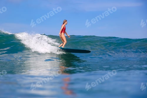 Preview: Woman Surfing on a Wave on a Sunny Day