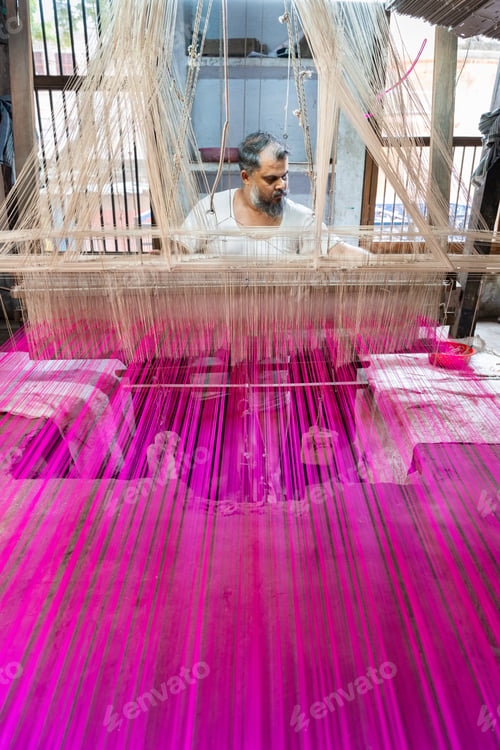 Preview: Man working concentrated on a traditional loom