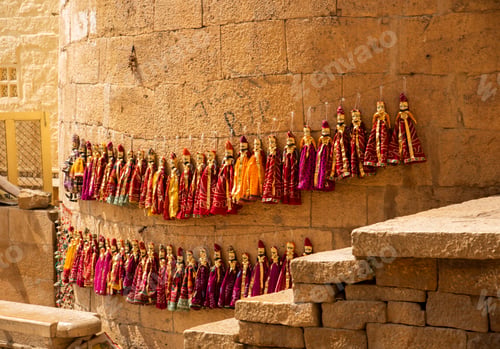 Preview: Colorful Rajasthani puppets hanging in the street of Jaisalmer, India.