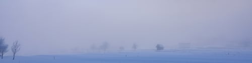 Preview: Banner 4:1 with snow-covered alpine village, lonely trees and huts in the fog