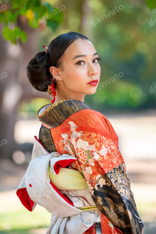 Preview: Elegant beauty in traditional kimono looking over her shoulder amid nature
