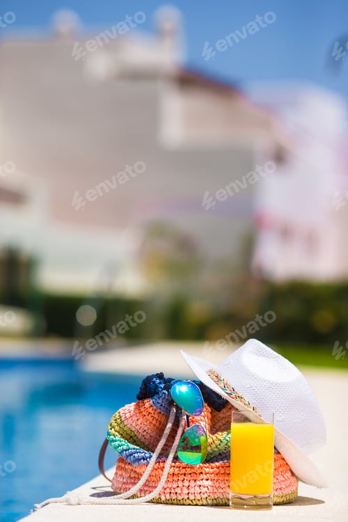Preview: Colorful stripe bag, sunglasses, orange juice, and straw white hat on summer vacation
