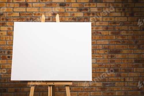 Preview: White canvas on wooden easel and copy space on brick wall background