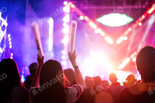 Preview: Crowd of concert stage lights and people fan audience silhouette raising hands or glow stick holding