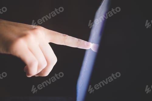 Preview: Side view of hand pointing at computer screen