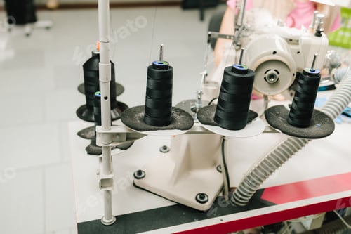 Preview: Spools of thread arranged on table for sewing and accurate garment creation.