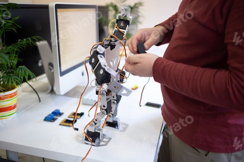 Preview: close-up shot male hands modeling a robot