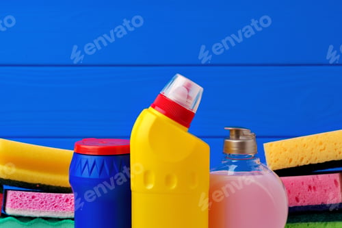 Preview: Various cleaning items against blue wooden background