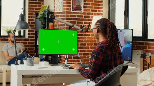 Preview: African american freelancer watching computer with greenscreen