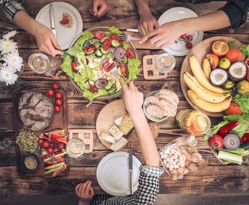 Preview: Enjoying dinner with friends. Top view of group of people having dinner together