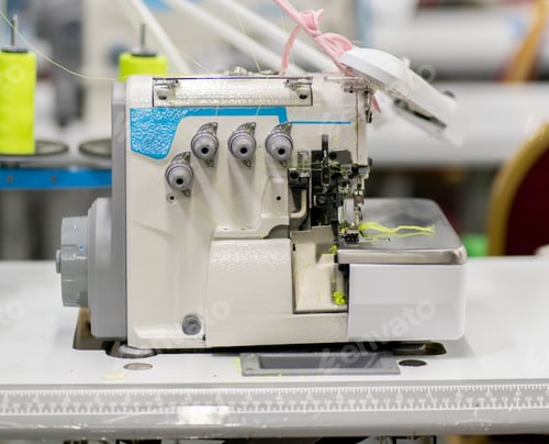 Preview: overlock. automatic sewing machine on the textile production factory