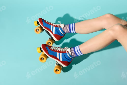 Preview: Young woman with thin skinny legs wearing colorful roller skates