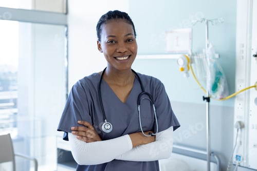 Preview: Portrait of happy african american female doctor in hospital room