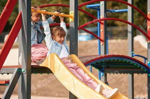 Preview: On a playground slide. Little girl is having fun on