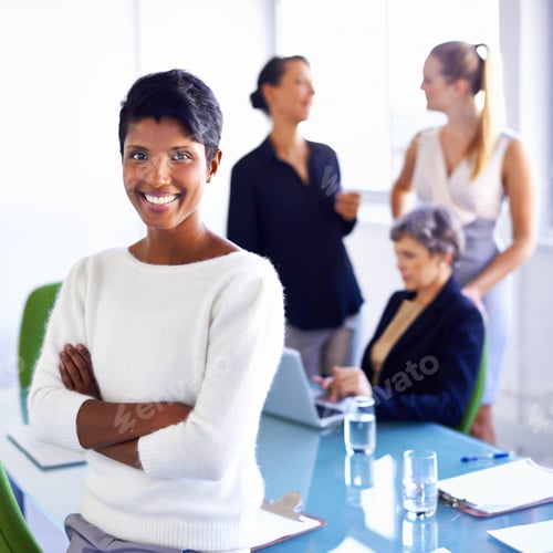 Preview: Portrait of a businesswoman standing in front of her colleagues during a meeting
