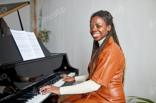 Preview: Woman learning to play the piano at school
