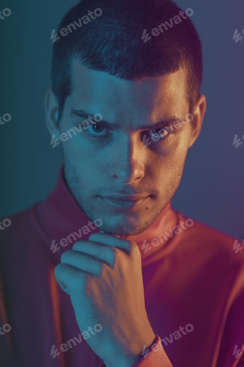 Preview: Studio close-up portrait of attractive male model. Color flash studio light